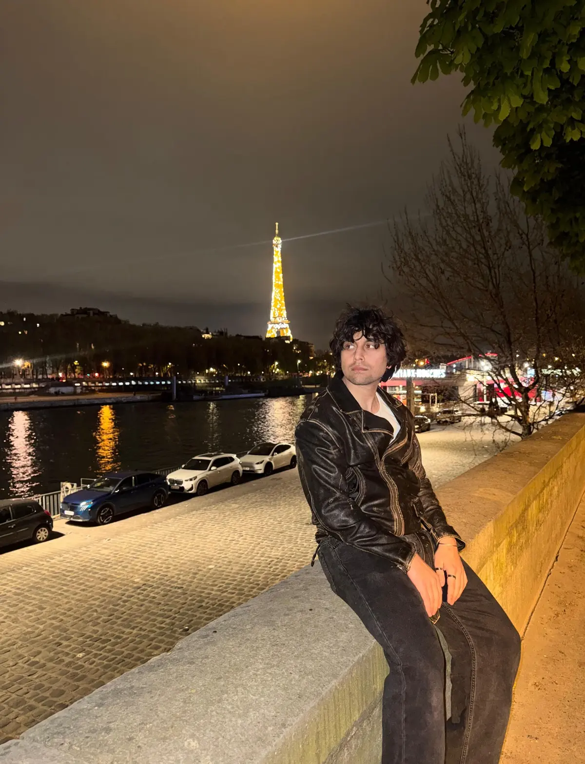 Moaiz Babar beside the River Seine in Paris with the Eiffel Tower in the background